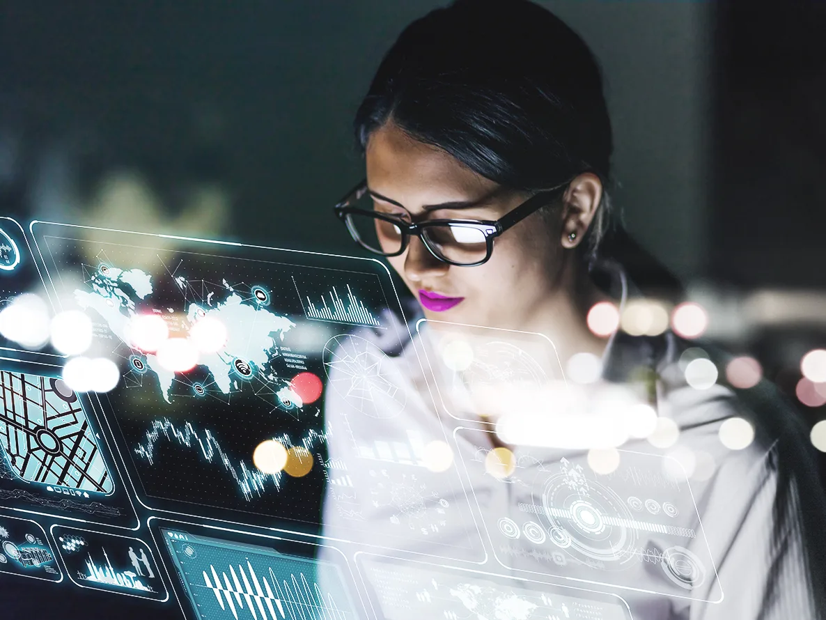 Woman watching a computer with an analytics and reporting platform. Woman leveraging database management services.